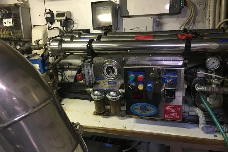  Yacht Photos Pics Engine room machinery of a 2008 Mangusta 80 yacht, featuring control panels and gauges.