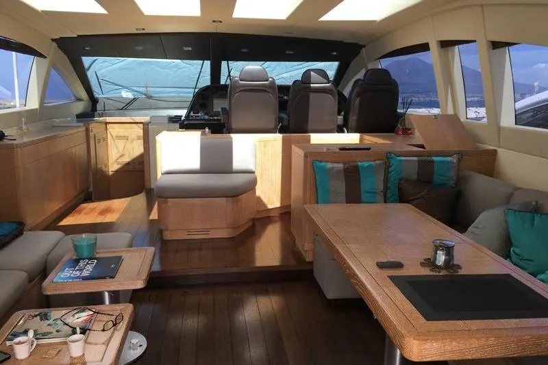  Yacht Photos Pics Luxurious interior of a 2008 Mangusta 80 yacht with modern seating and wooden finishes.