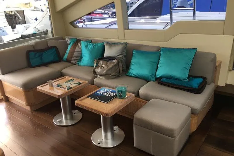  Yacht Photos Pics Luxurious 2008 Mangusta 80 yacht interior with plush seating and vibrant turquoise cushions.