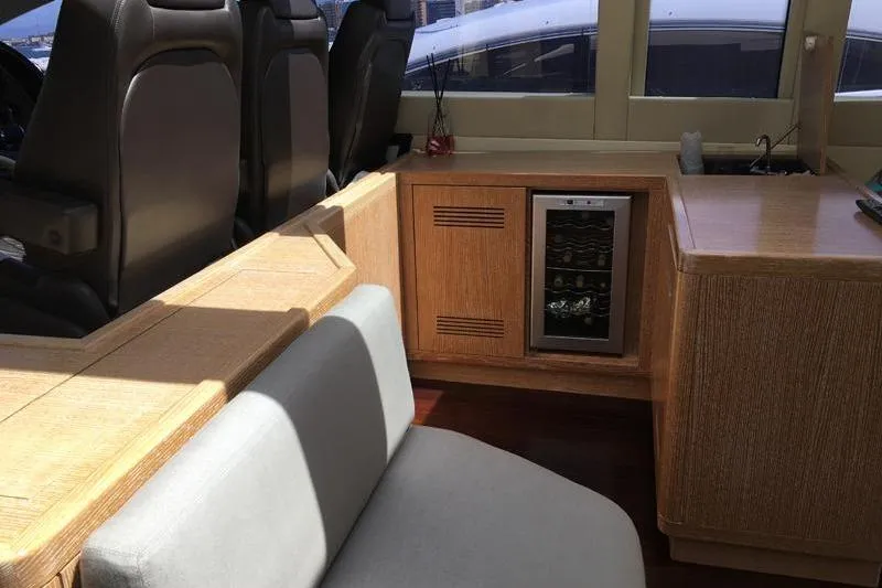  Yacht Photos Pics Interior of 2008 Mangusta 80 yacht with seating and mini fridge.