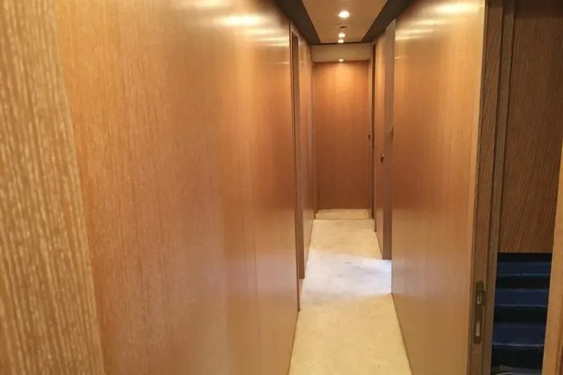  Yacht Photos Pics Hallway inside 2008 Mangusta 80 yacht with wooden paneling and recessed lighting.