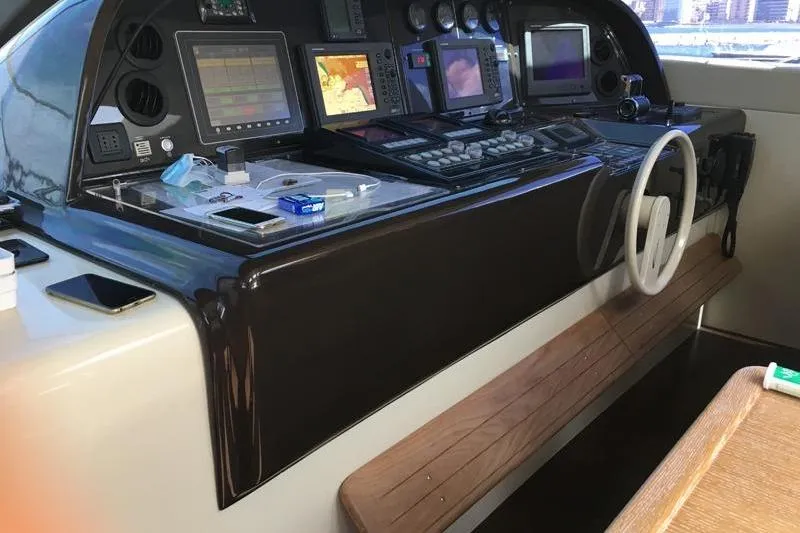  Yacht Photos Pics Control panel of a 2008 Mangusta 80 yacht with navigation equipment and steering wheel.