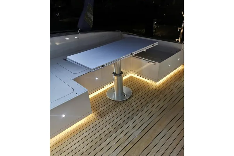  Yacht Photos Pics Luxurious 2008 Mangusta 80 yacht deck with sleek table and ambient lighting.