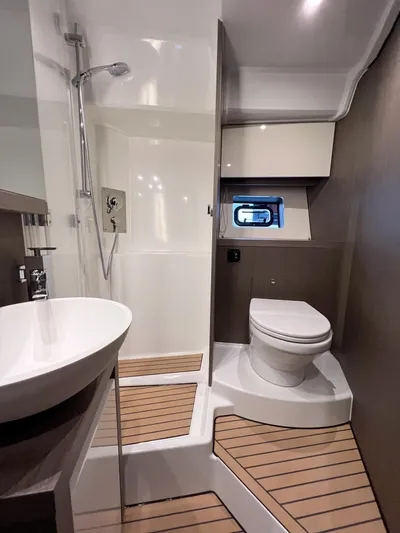 In Stock Yacht Photos Pics Luxurious bathroom in 2024 Beneteau Gran Turismo 45 yacht with modern fixtures.