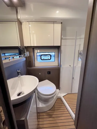 In Stock Yacht Photos Pics 2024 Beneteau Gran Turismo 45 yacht bathroom with modern fixtures and wooden flooring.