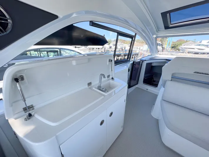 In Stock Yacht Photos Pics 2024 Beneteau Gran Turismo 45 interior with sleek kitchenette and modern seating.