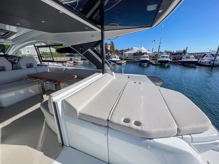 In Stock Yacht Photos Pics 2024 Beneteau Gran Turismo 45 yacht interior with seating and waterfront view.