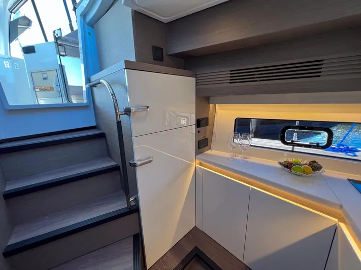 In Stock Yacht Photos Pics 2024 Beneteau Gran Turismo 45 interior with modern cabinetry and elegant lighting.