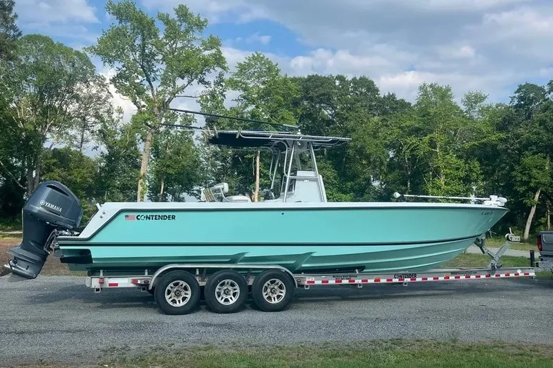  Yacht Photos Pics 2011 Contender 32 ST boat on trailer, parked outdoors with trees in background.