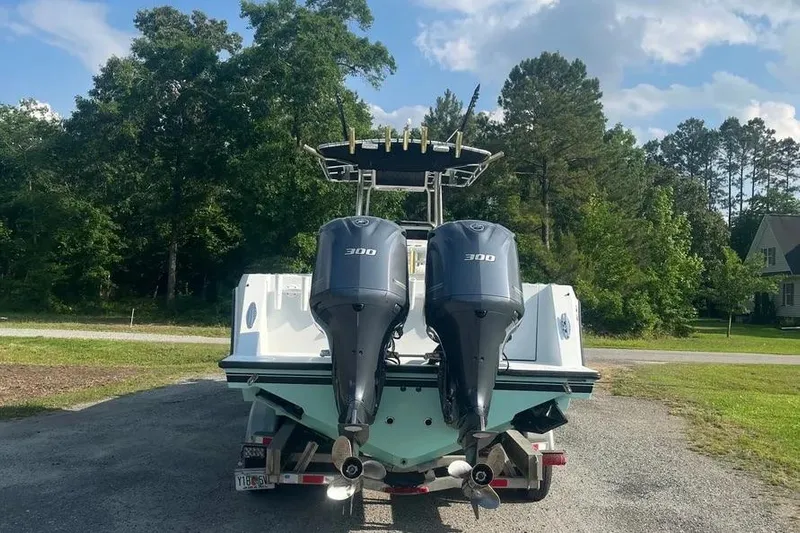  Yacht Photos Pics 2011 Contender 32 ST boat with dual 300 horsepower engines, parked outdoors.