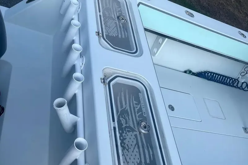  Yacht Photos Pics 2011 Contender 32 ST boat deck with rod holders and storage compartments.