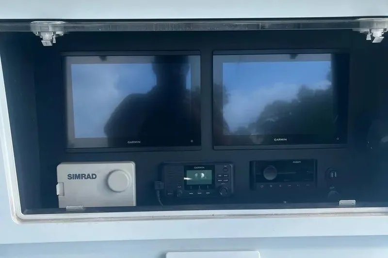  Yacht Photos Pics 2011 Contender 32 ST dashboard with Garmin and Simrad navigation displays.