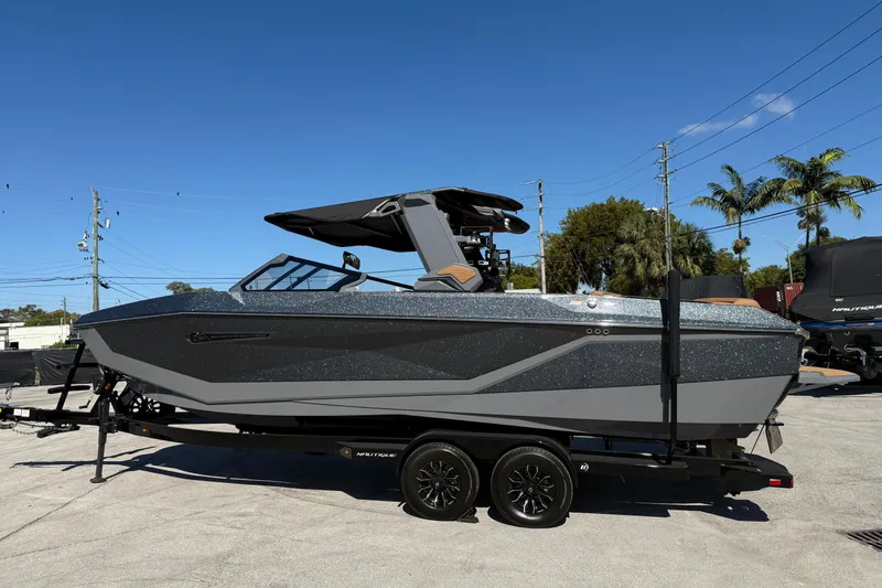  Yacht Photos Pics 2026 Nautique Super Air Nautique G25 Coastal Edition boat on trailer, side view.
