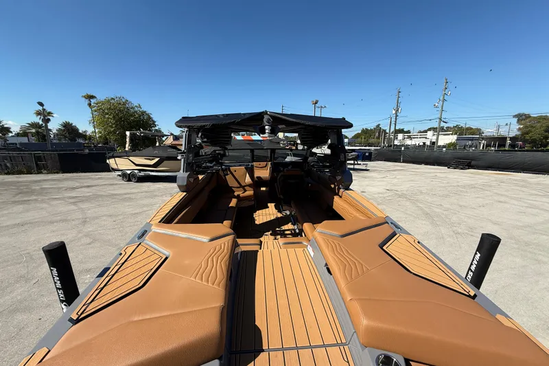  Yacht Photos Pics 2026 Nautique Super Air Nautique G25 Coastal Edition boat interior with tan seating and sleek design.