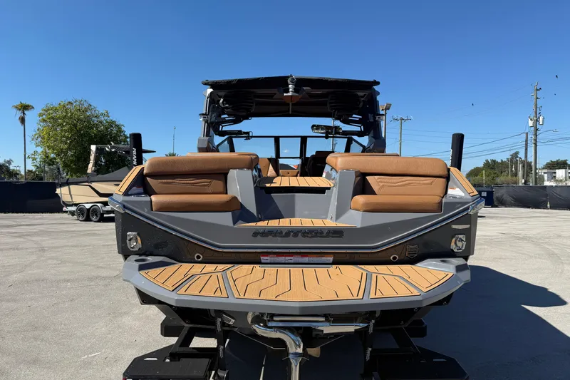  Yacht Photos Pics 2026 Nautique Super Air Nautique G25 Coastal Edition boat, rear view, in a parking area.