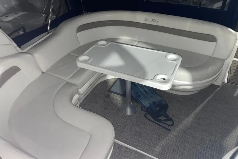  Yacht Photos Pics 2003 Sea Ray 340 Sundancer interior with white seating and table on carpeted floor.