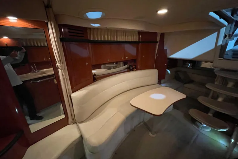  Yacht Photos Pics Interior of 2003 Sea Ray 340 Sundancer yacht with elegant seating and wooden cabinetry.