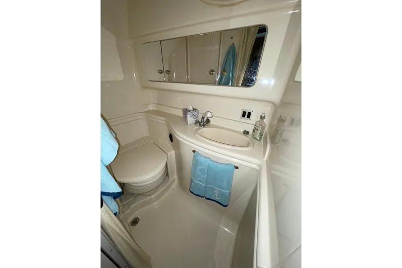  Yacht Photos Pics Bathroom interior of 2003 Sea Ray 340 Sundancer yacht, featuring sink and toilet.