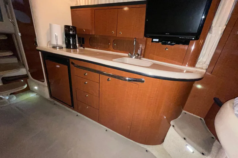  Yacht Photos Pics 2003 Sea Ray 340 Sundancer interior kitchen with wood cabinetry and modern appliances.