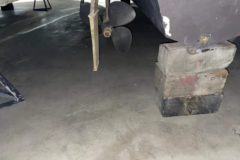  Yacht Photos Pics 2003 Sea Ray 340 Sundancer propeller and hull on wooden blocks in storage.