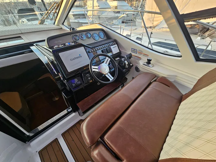 Levon II Yacht Photos Pics 2017 Sea Ray Sundancer 350 Coupe helm with Garmin navigation system and leather seating.