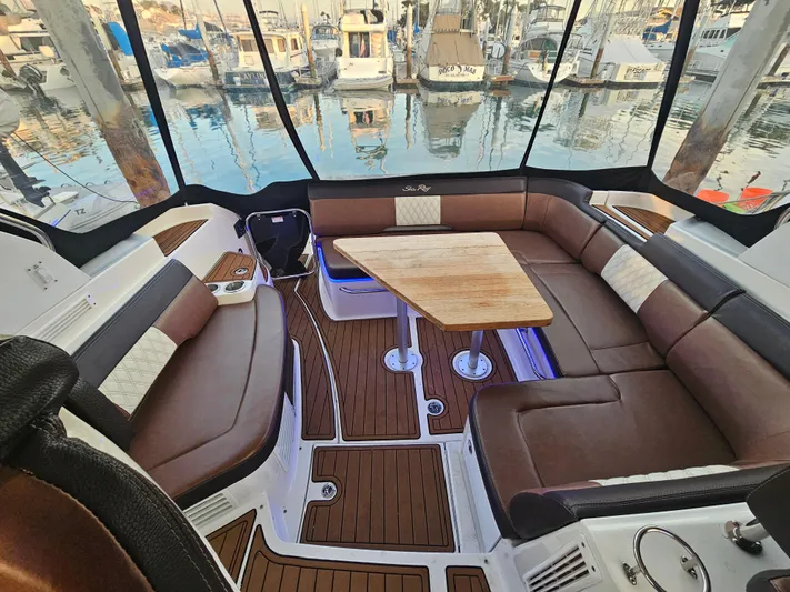 Levon II Yacht Photos Pics Luxurious 2017 Sea Ray Sundancer 350 Coupe interior with brown seating and wooden table.