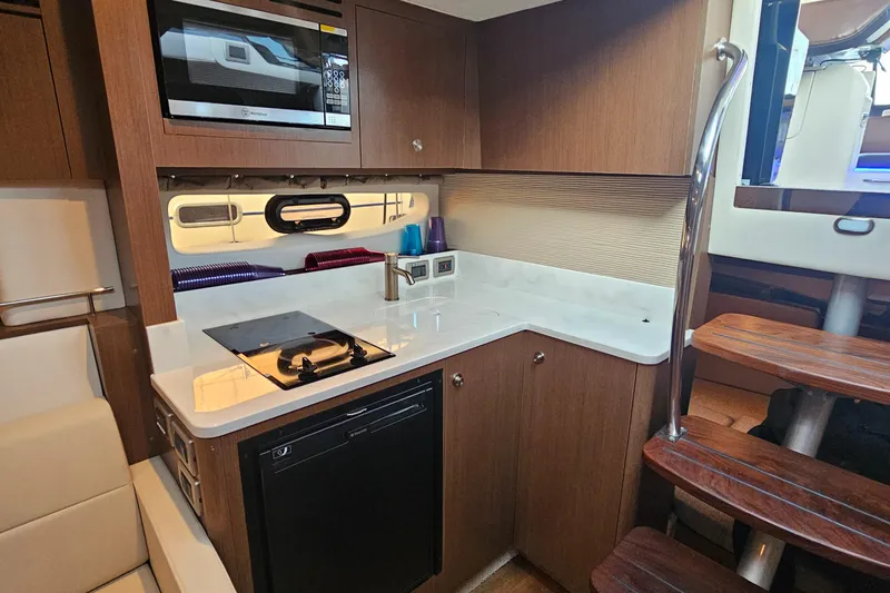 Levon II Yacht Photos Pics 2017 Sea Ray Sundancer 350 Coupe kitchen with modern appliances and wooden cabinetry.