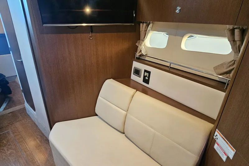 Levon II Yacht Photos Pics 2017 Sea Ray Sundancer 350 Coupe interior with beige seating and wall-mounted TV.