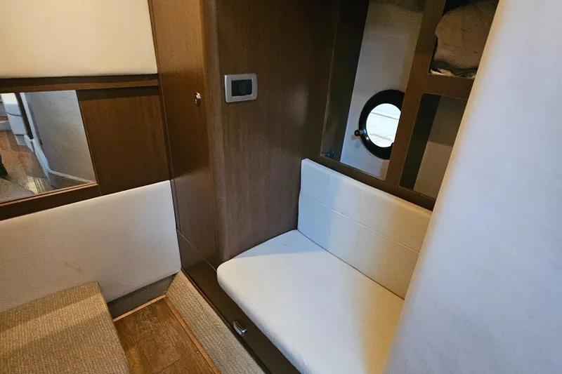 Levon II Yacht Photos Pics Interior of 2017 Sea Ray Sundancer 350 Coupe with seating and porthole window.