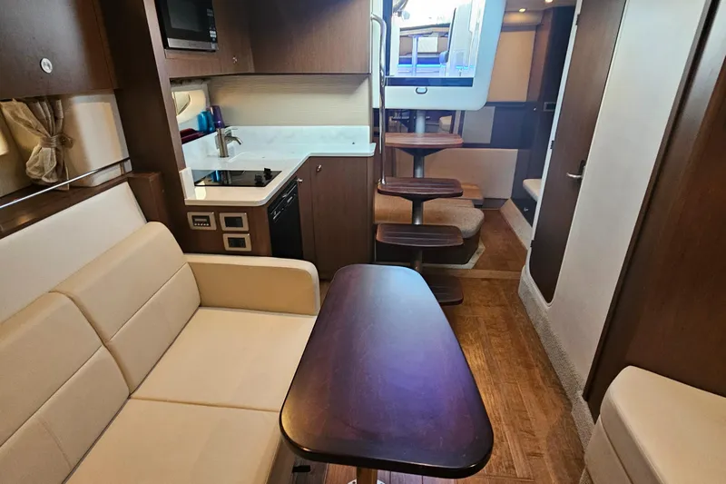 Levon II Yacht Photos Pics Interior of 2017 Sea Ray Sundancer 350 Coupe with modern kitchen and seating area.