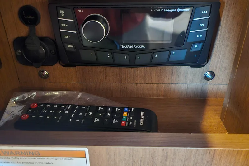 Levon II Yacht Photos Pics 2017 Sea Ray Sundancer 350 Coupe audio system with remote controls in wooden cabinet.