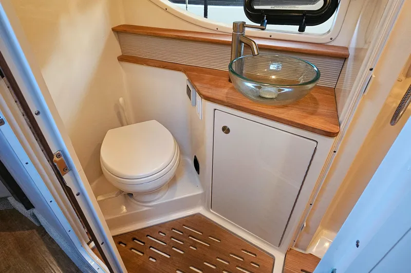 Levon II Yacht Photos Pics 2017 Sea Ray Sundancer 350 Coupe bathroom with modern sink and wooden accents.