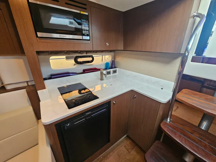Levon II Yacht Photos Pics 2017 Sea Ray Sundancer 350 Coupe kitchen with modern appliances and wooden cabinetry.