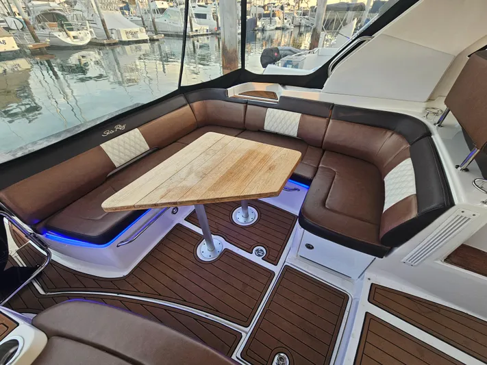 Levon II Yacht Photos Pics Luxurious seating area on 2017 Sea Ray Sundancer 350 Coupe with wooden table and marina view.