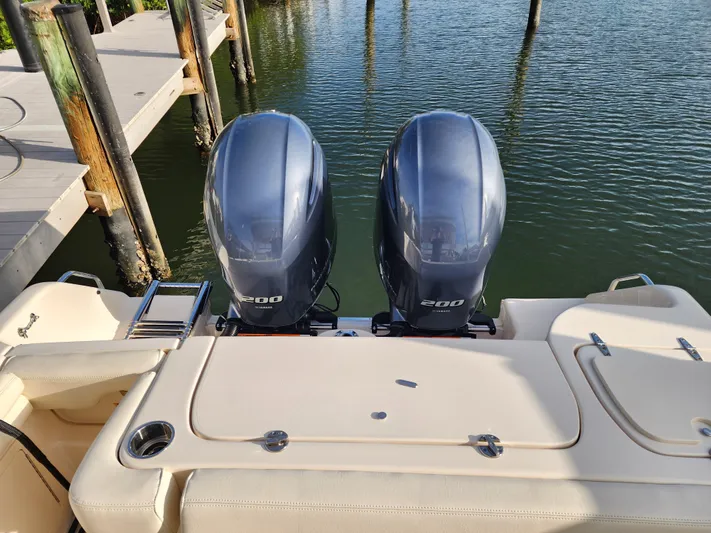  Yacht Photos Pics 2023 Grady-White Freedom 275 boat with dual outboard engines at dock.