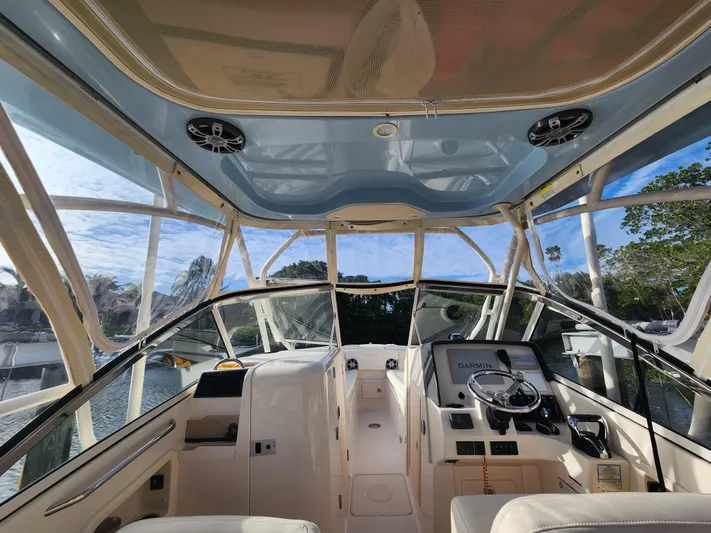  Yacht Photos Pics 2023 Grady-White Freedom 275 boat interior with modern dashboard and steering wheel.