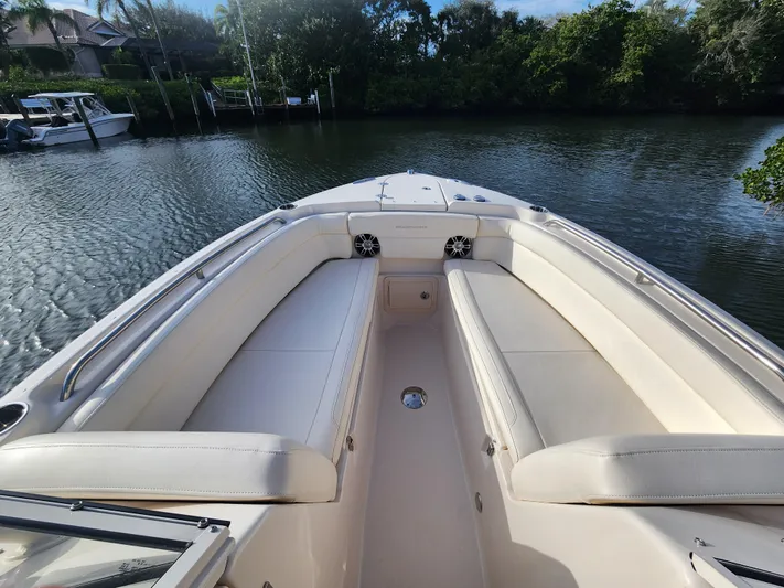  Yacht Photos Pics 2023 Grady-White Freedom 275 boat interior with spacious seating on calm water.