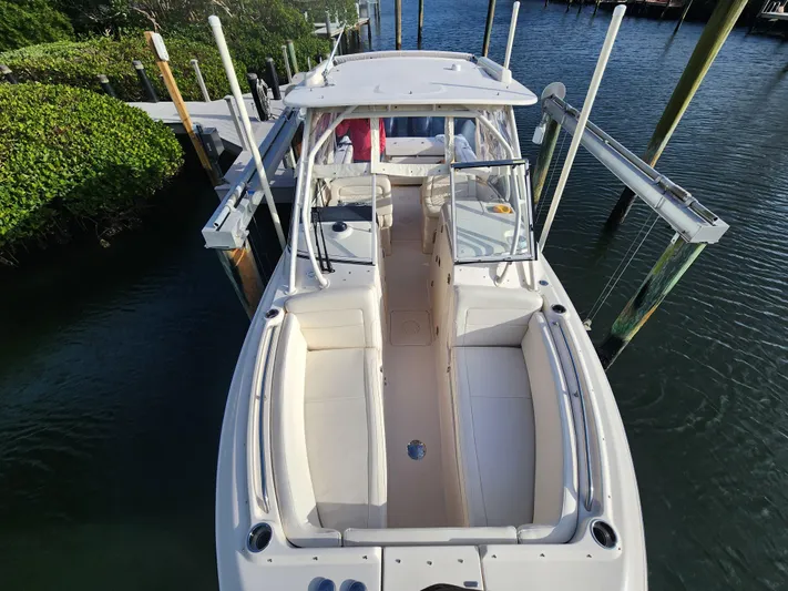 Yacht Photos Pics 2023 Grady-White Freedom 275 boat docked in a serene marina setting.