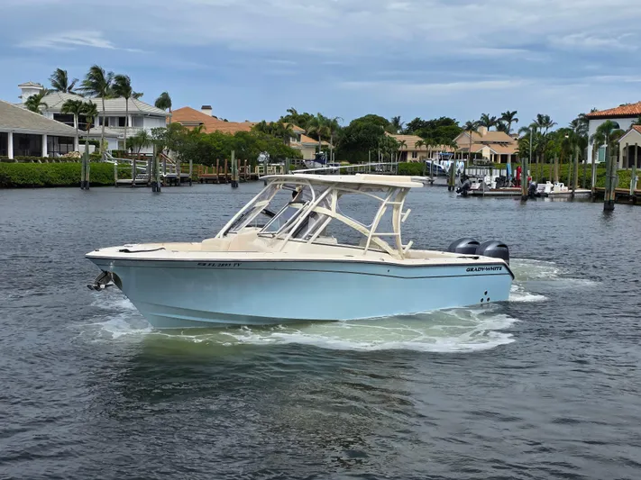  Yacht Photos Pics 2023 Grady-White Freedom 275 boat cruising in a scenic waterfront setting.