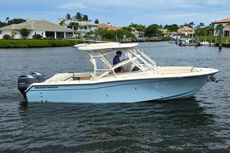  Yacht Photos Pics 2023 Grady-White Freedom 275 boat cruising on a scenic waterway.