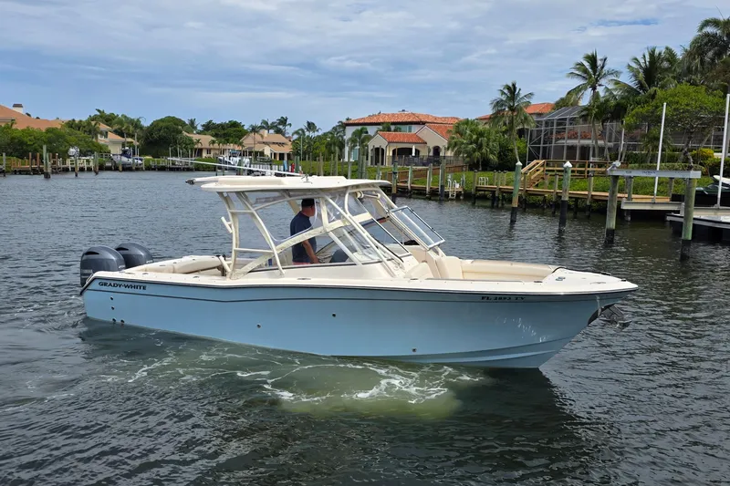  Yacht Photos Pics 2023 Grady-White Freedom 275 boat cruising on a scenic waterway.