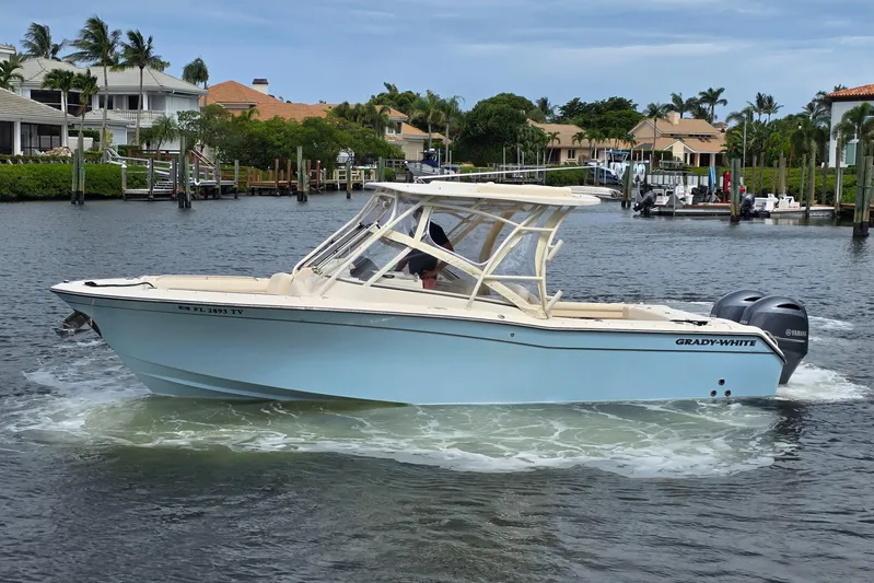  Yacht Photos Pics 2023 Grady-White Freedom 275 boat cruising in a scenic waterfront setting.