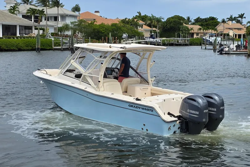  Yacht Photos Pics 2023 Grady-White Freedom 275 boat cruising on a scenic waterway.