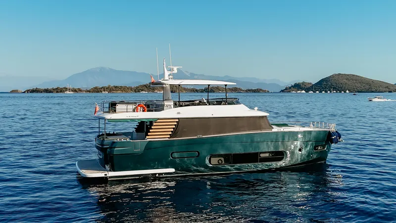  Yacht Photos Pics 2024 Azimut Magellano 66 yacht on serene blue waters with scenic island backdrop.