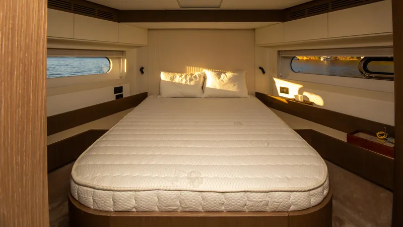  Yacht Photos Pics Luxurious bedroom interior of 2024 Azimut Magellano 66 yacht with large bed and windows.