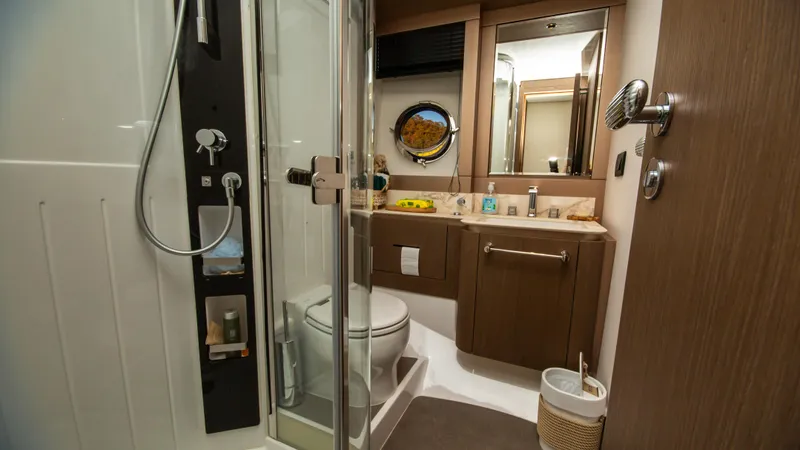  Yacht Photos Pics Luxurious bathroom interior of 2024 Azimut Magellano 66 yacht with modern amenities.