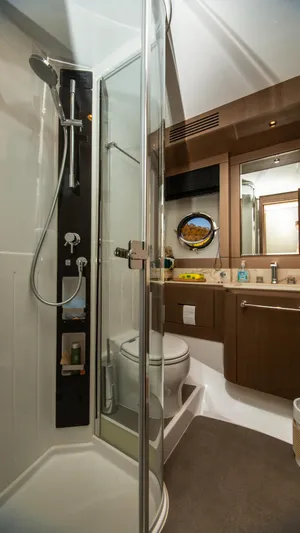  Yacht Photos Pics Luxurious bathroom in 2024 Azimut Magellano 66 yacht with modern shower and elegant fixtures.