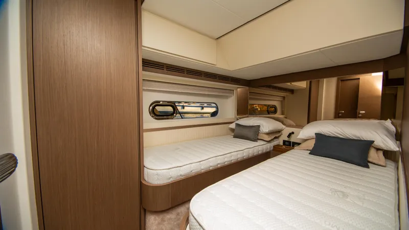  Yacht Photos Pics Luxurious twin cabin interior of 2024 Azimut Magellano 66 yacht, featuring elegant bedding and wood finishes.