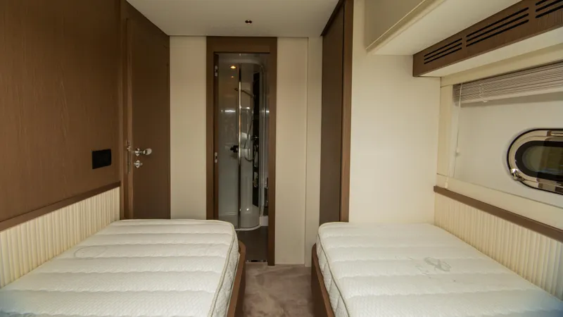  Yacht Photos Pics Twin cabin interior of 2024 Azimut Magellano 66 yacht, featuring modern design and ensuite bathroom.