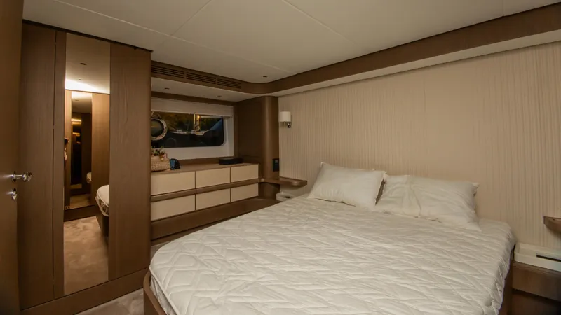  Yacht Photos Pics Luxurious bedroom interior of 2024 Azimut Magellano 66 yacht with modern furnishings.